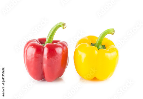 Red and yellow sweet pepper on white