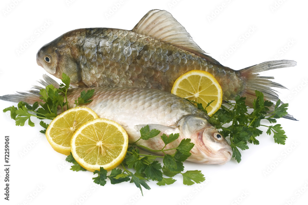 Raw fish with lemon and parsley isolated on white background Raw fish with lemon and parsley isolated on white background