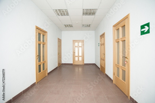 corridor with five wooden doors