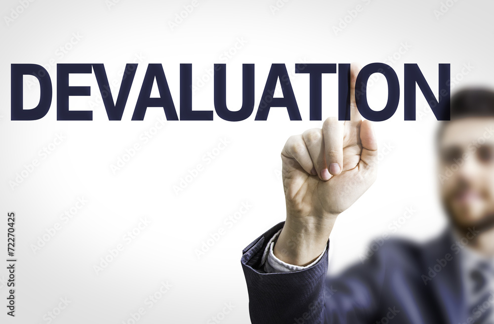Business man pointing the text: Devaluation Business man pointing the text: Devaluation