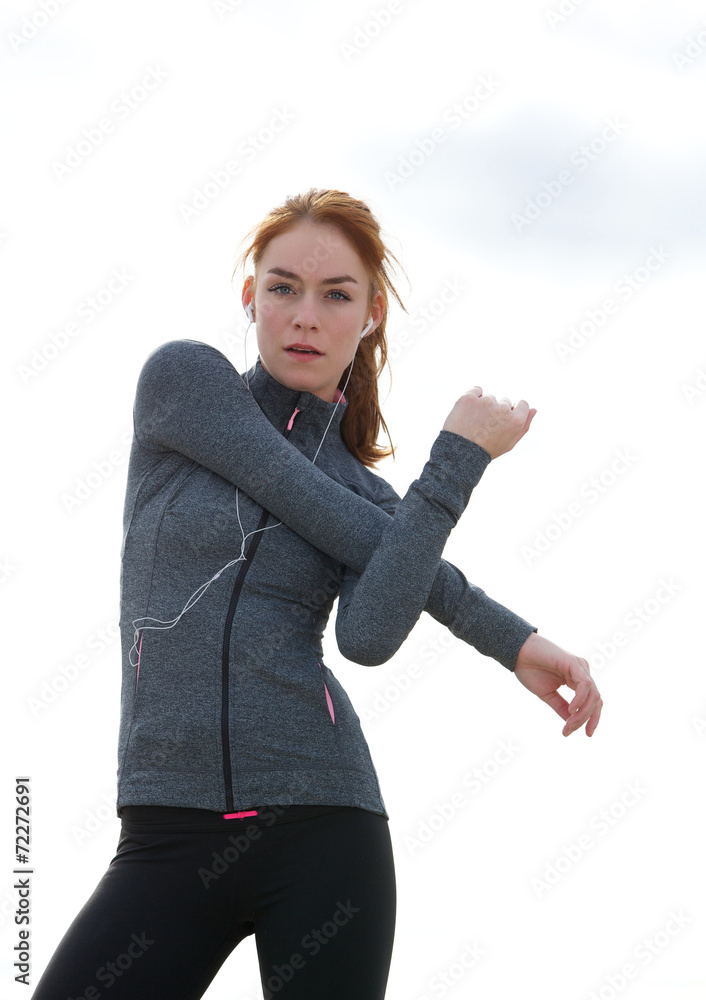 Sporty young woman stretching muscles Sporty young woman stretching muscles