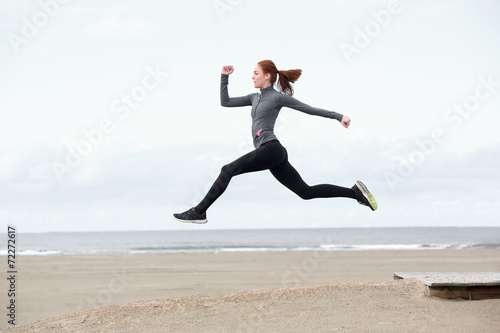 Fit young woman running and jumping
