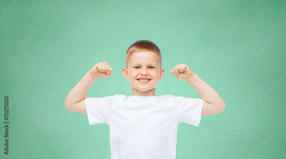 happy little boy in white t-shirt flexing biceps
