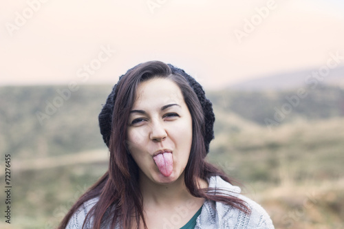 Young woman with her tongue out photo