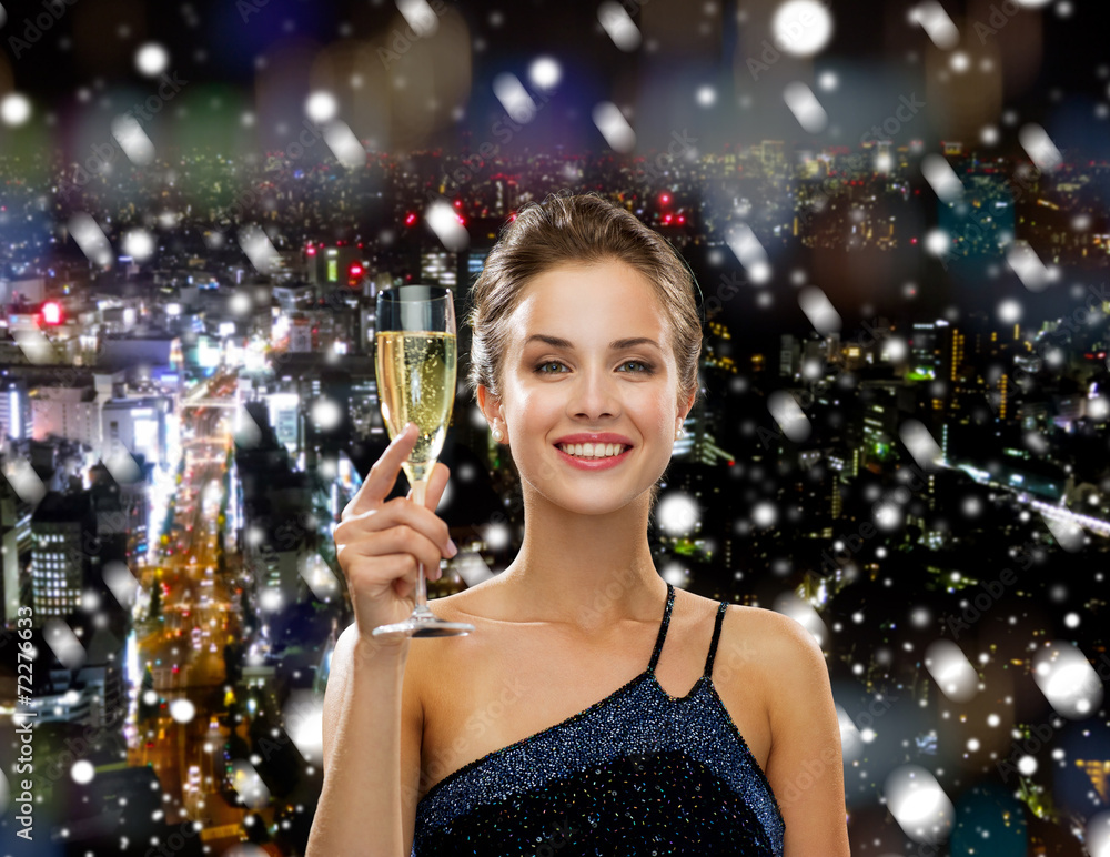 smiling woman holding glass of sparkling wine smiling woman holding glass of sparkling wine
