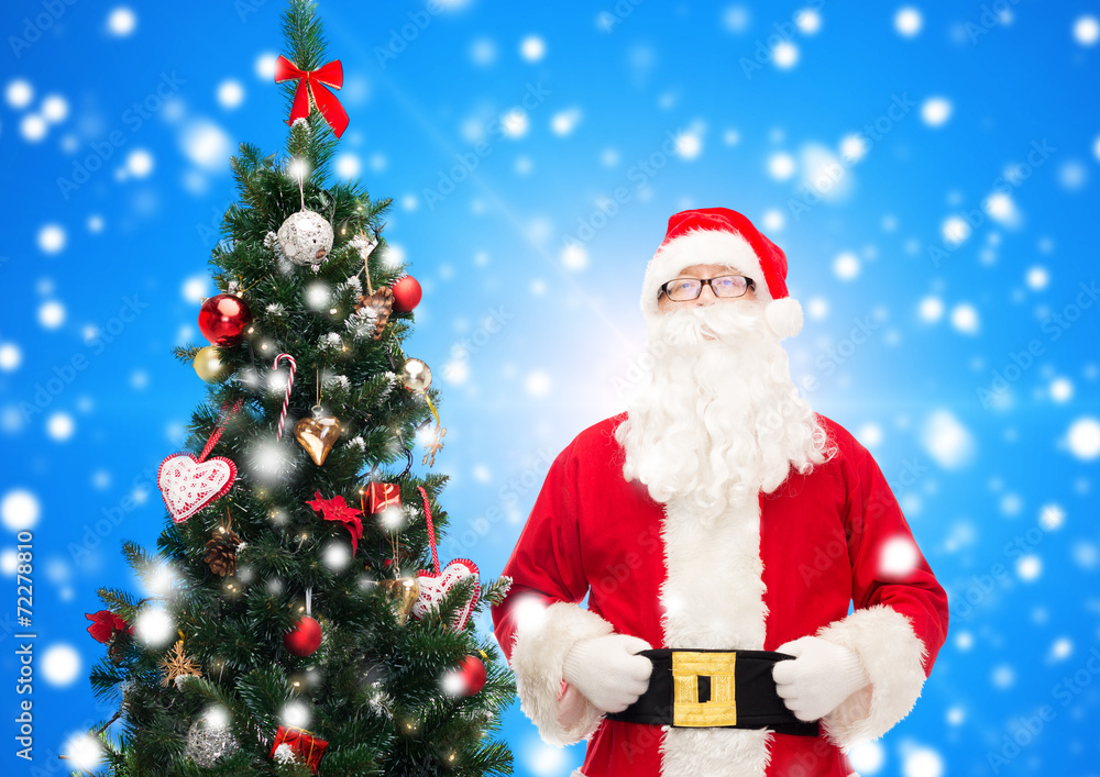 man in costume of santa claus with christmas tree
