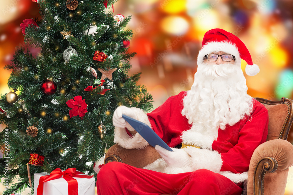 man in costume of santa claus with tablet pc man in costume of santa claus with tablet pc