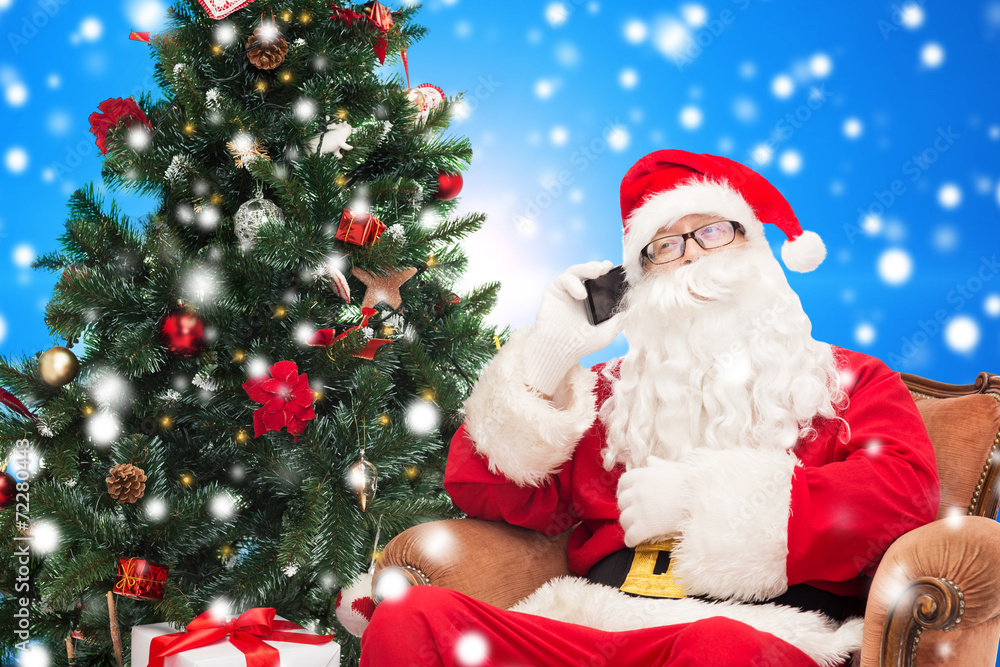 santa claus with smartphone and christmas tree santa claus with smartphone and christmas tree