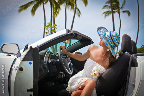 Beautiful young woman resting in her car photo