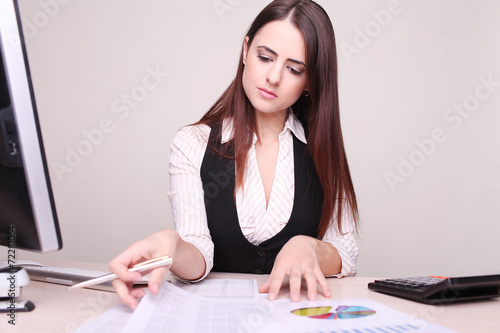 Portrait of a beautiful young business woman doing some paperwor