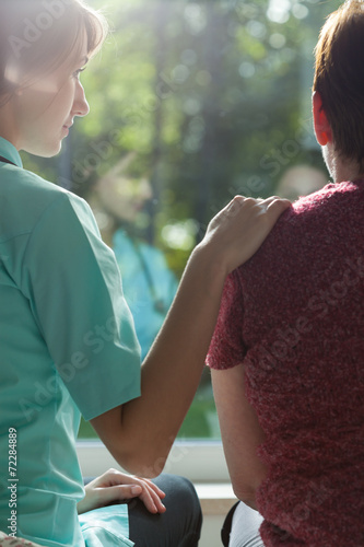 Nurse assisting adult woman