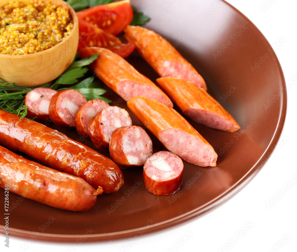 Assortment of tasty thin sausages on plate isolated on white Assortment of tasty thin sausages on plate isolated on white