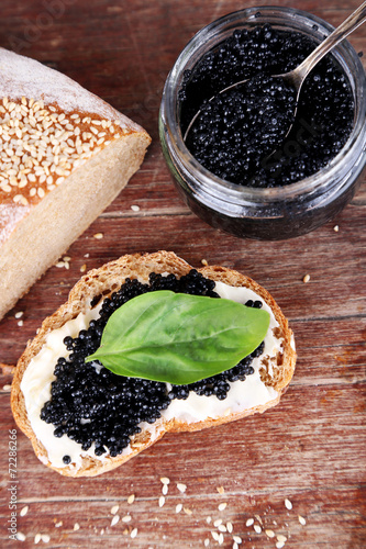 Slices of bread with butter and black caviar