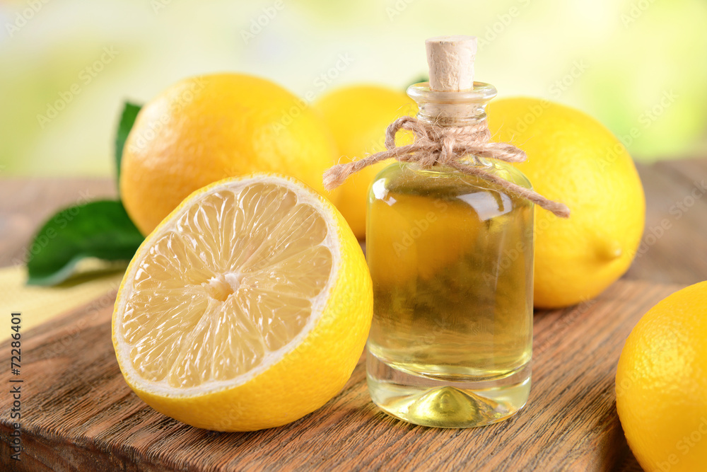 Lemon oil on table on light background Lemon oil on table on light background