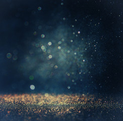 glitter vintage lights background. gold, silver, blue and black.