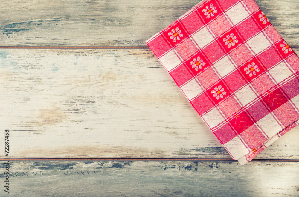 Top view of checkered napkin on old wooden table Top view of checkered napkin on old wooden table