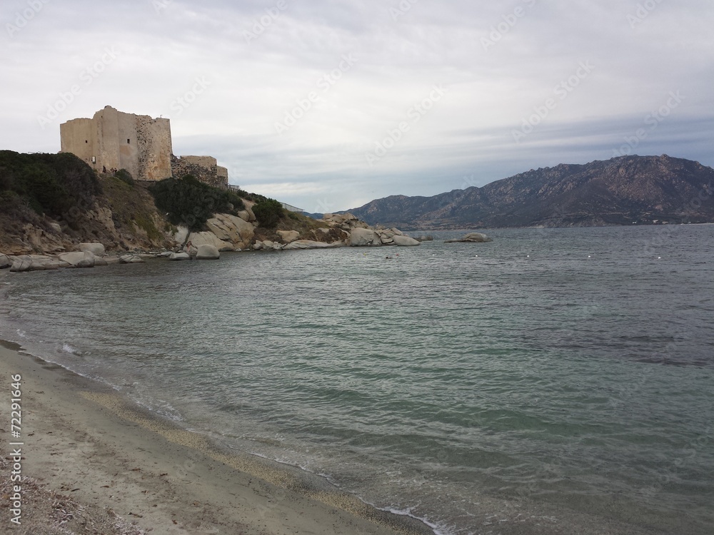 A Castle in front of the sea in a cloudy day
