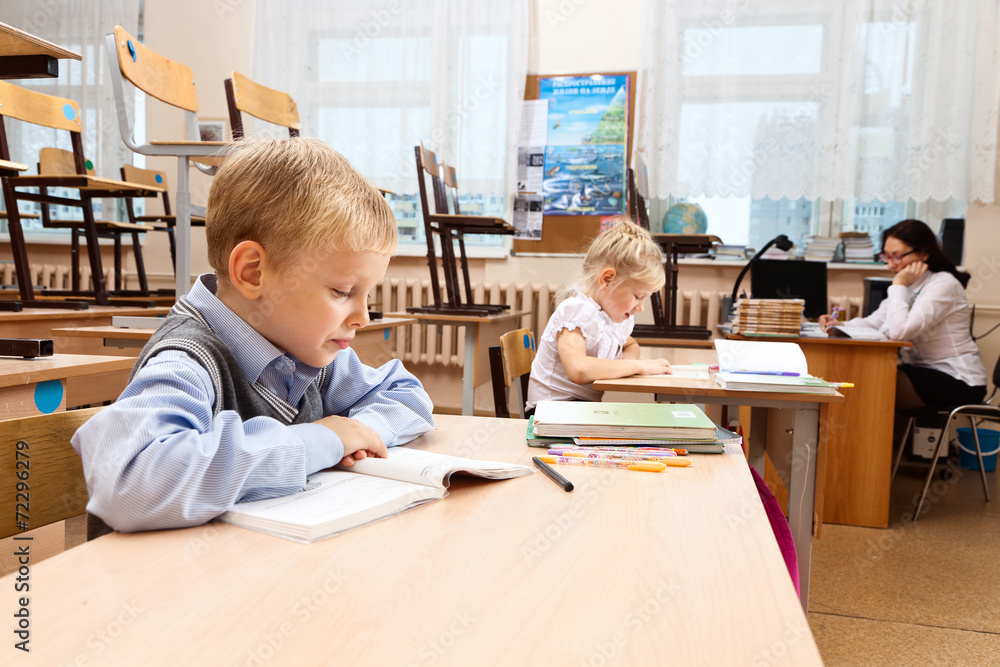 Schoolchildren in empty classroom