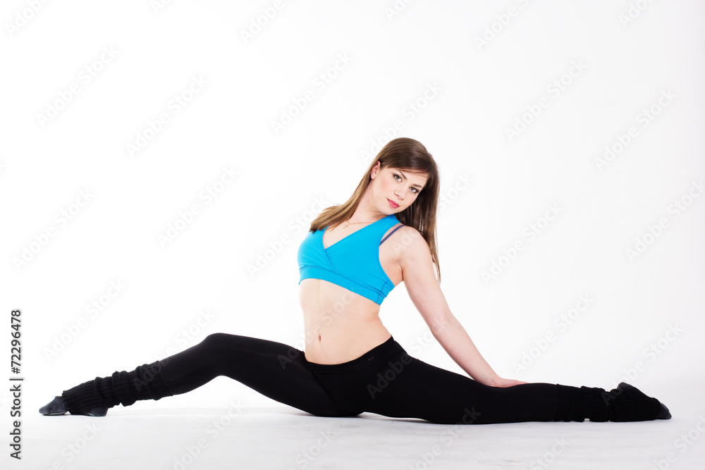 Young happy woman does fitness exercise
