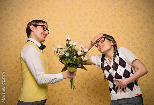 Male nerd giving flowers to female nerd