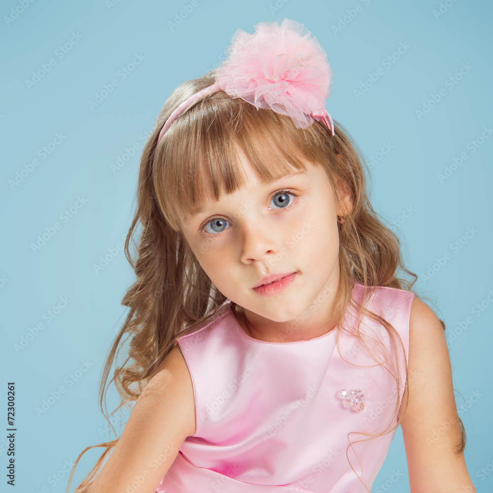 Little girl posing in a studio over colour background Little girl posing in a studio over colour background