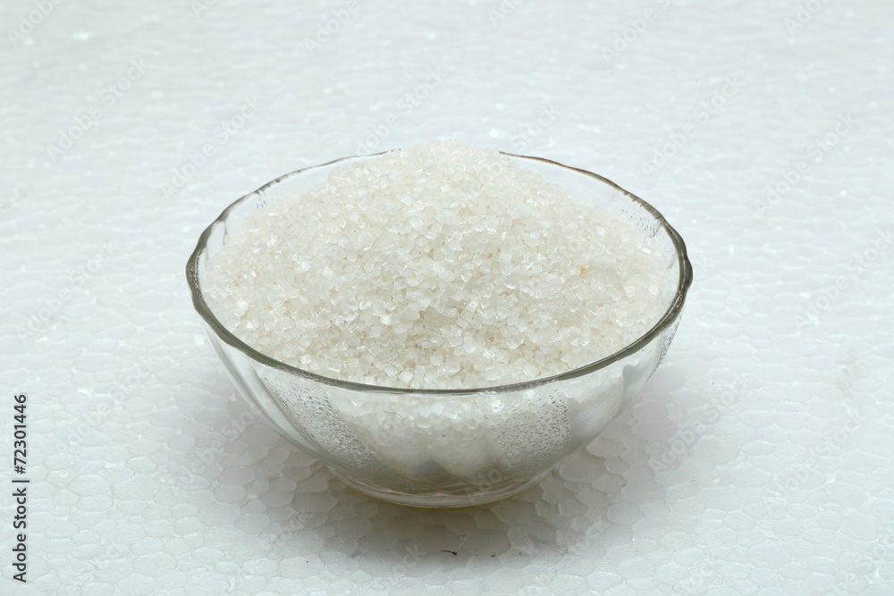 Sugar in glass bowl isolated on white Sugar in glass bowl isolated on white