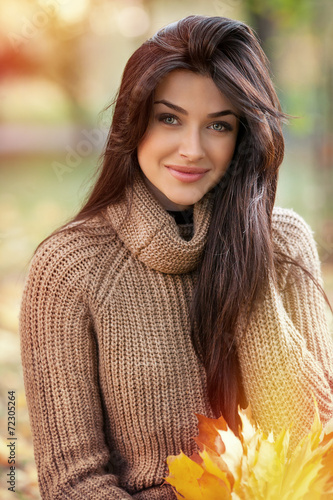 portrait of beautiful girl on yellow leaves. Outdoor