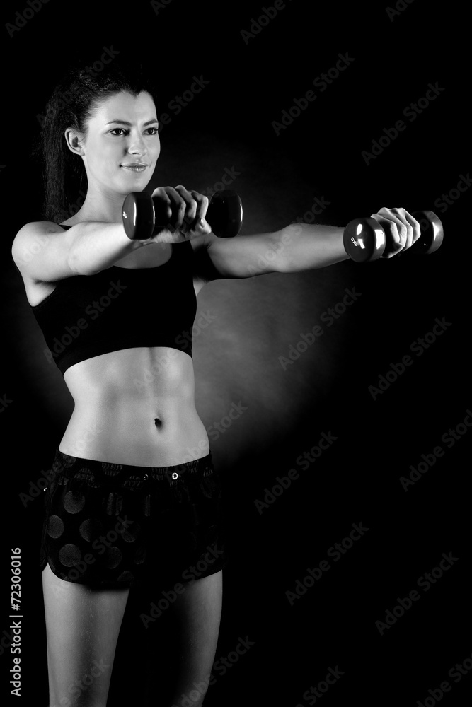 beautiful sporty muscular woman working out with dumbbells beautiful sporty muscular woman working out with dumbbells