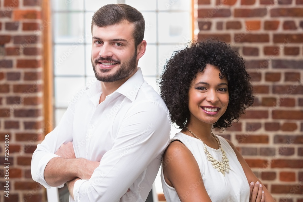 Confident business people with arms crossed in office Confident business people with arms crossed in office