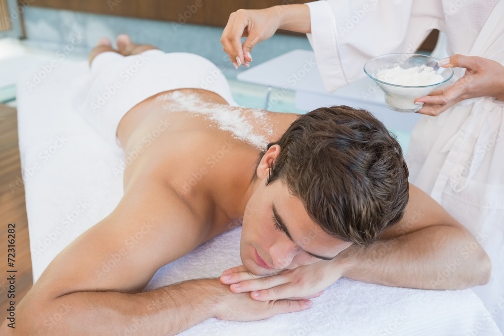 Man receiving treatment at spa center Man receiving treatment at spa center