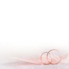 Two Golden Wedding Rings and  Feather -  soft, white