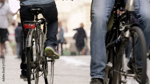 People riding bicycles in the city streets in the afternoon