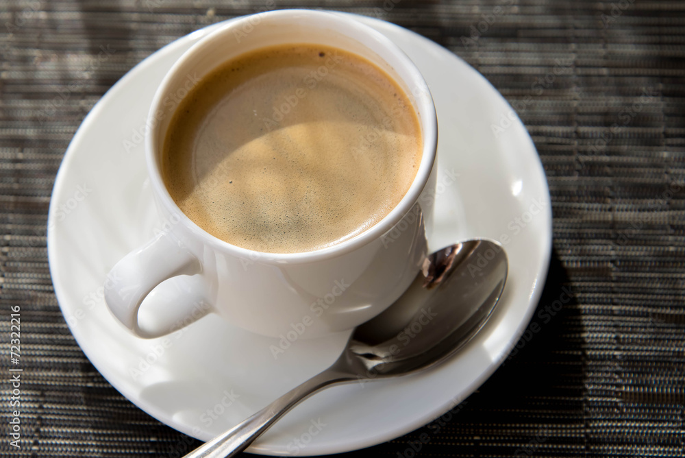 Fototapeta premium morning cup of espresso in the morning sun