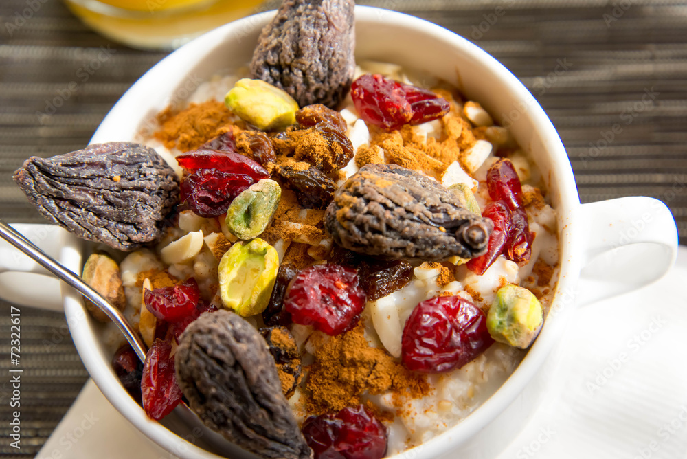 dried figs, oatmeal and orange juice breakfast setting