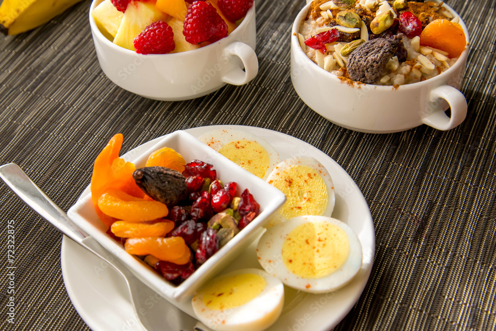 Fresh fruit and oatmeal with healthy toppings for breakfast Fresh fruit and oatmeal with healthy toppings for breakfast
