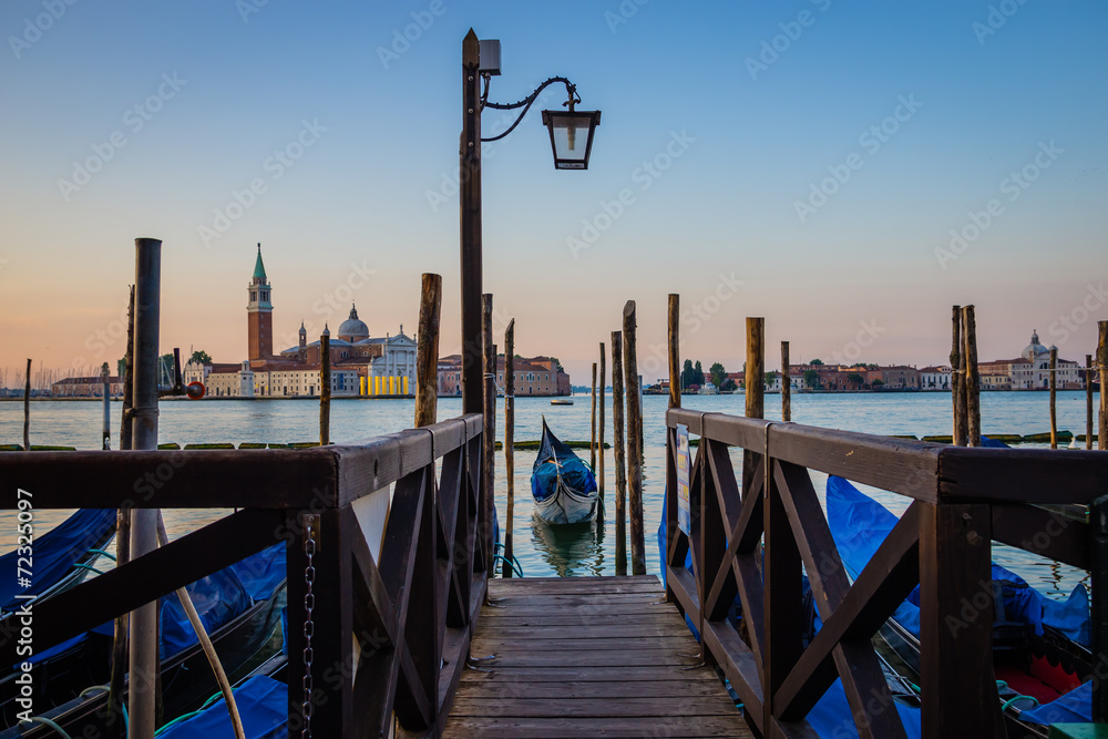 Gondola at pier at sunrise, Venice, Italy