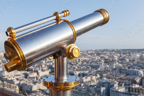 Telescope mounted on the railings of Eiffel Tower in Paris