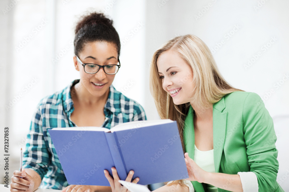 smiling student girls reading book at school smiling student girls reading book at school