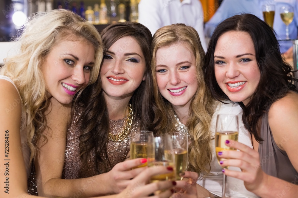 Pretty friends having a drink together