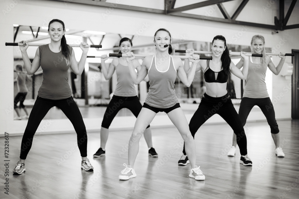 group of smiling people working out with barbells group of smiling people working out with barbells