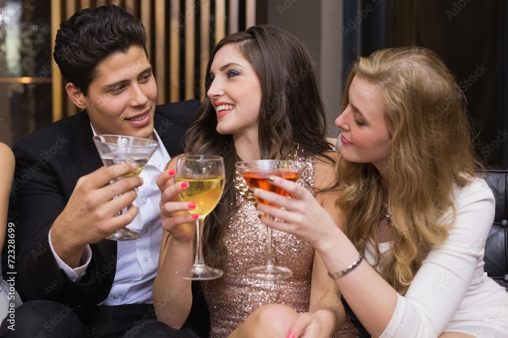 Happy friends having a drink together Happy friends having a drink together
