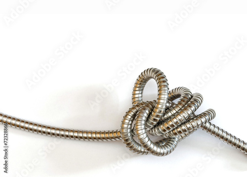 an intricate knot formed by a flexible metal hose