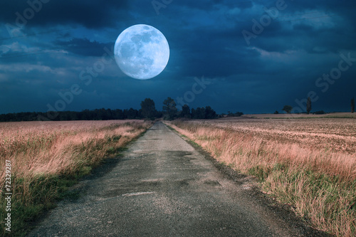 Moonrise over asphalt road