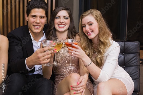 Happy friends having a drink together