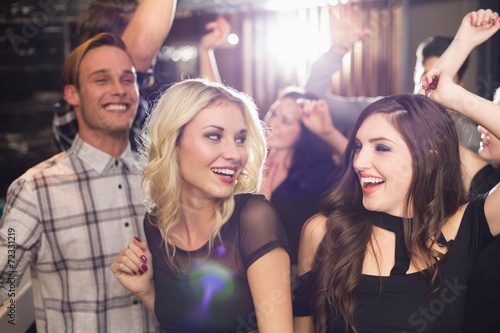 Stylish friends dancing and smiling