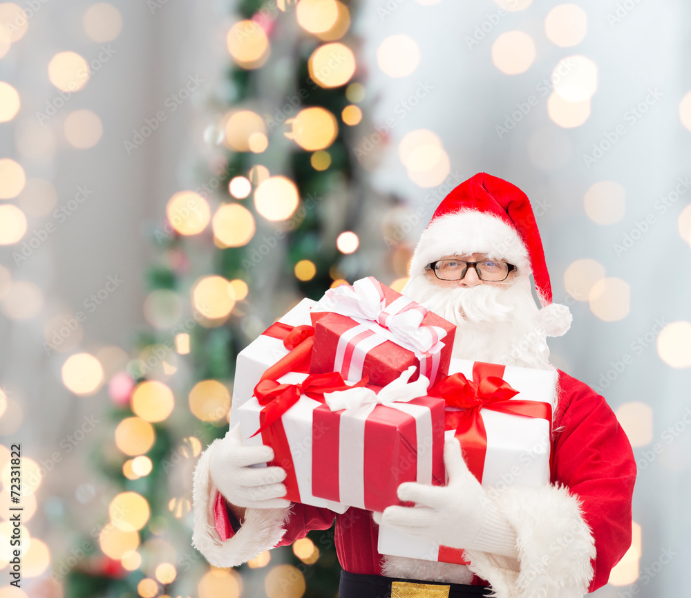 man in costume of santa claus with gift boxes man in costume of santa claus with gift boxes