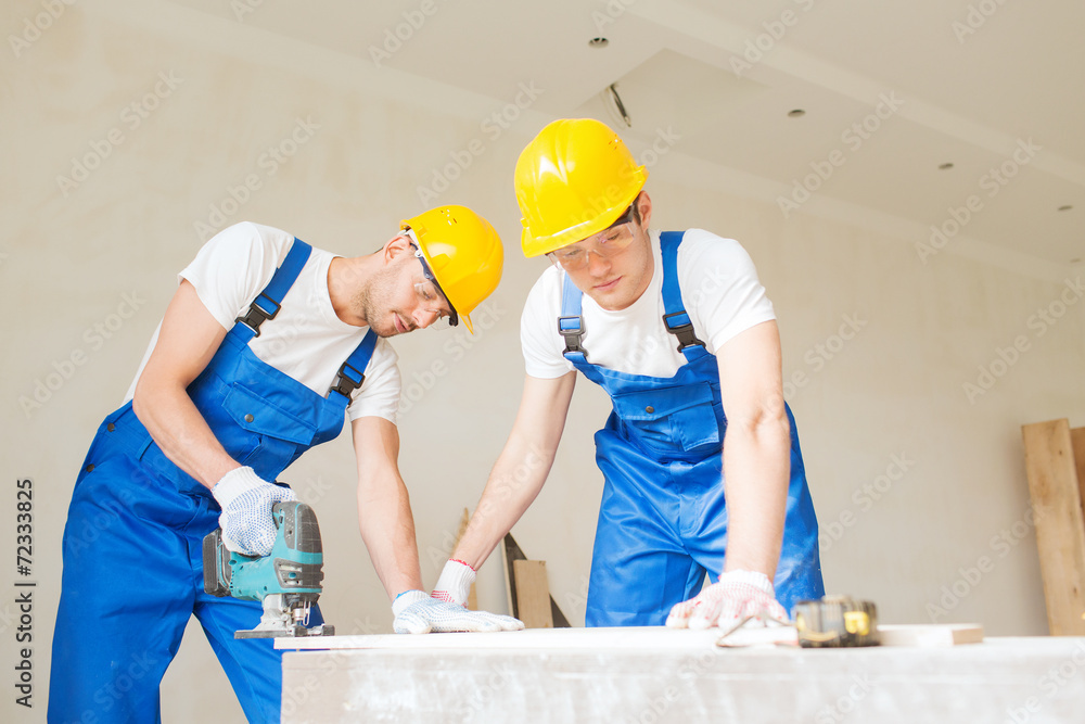 group of builders with tools indoors group of builders with tools indoors