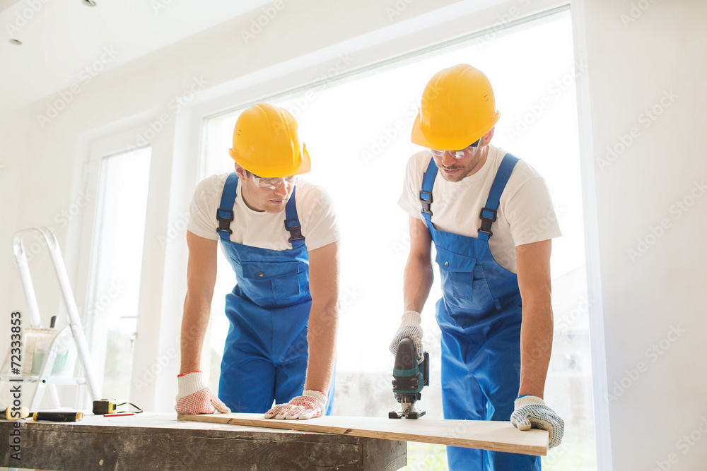 group of builders with tools indoors group of builders with tools indoors