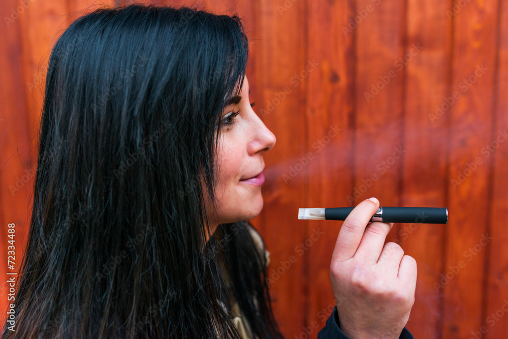 Fototapeta premium Woman smoking with electronic cigarette