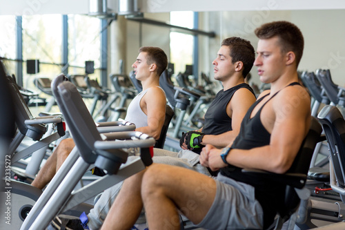 men working out on exercise bike in gym